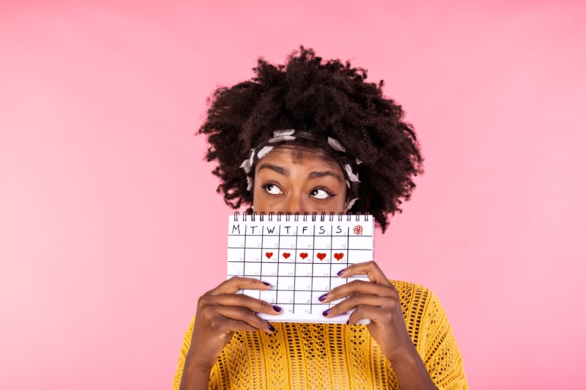 Kvinne med menstruasjonskalender i hånden